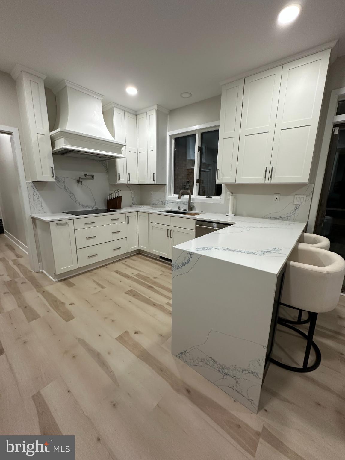 11530 Magnolia Court Issue, MD 20645 - Photo 3 of 31 a kitchen with white cabinets and sink