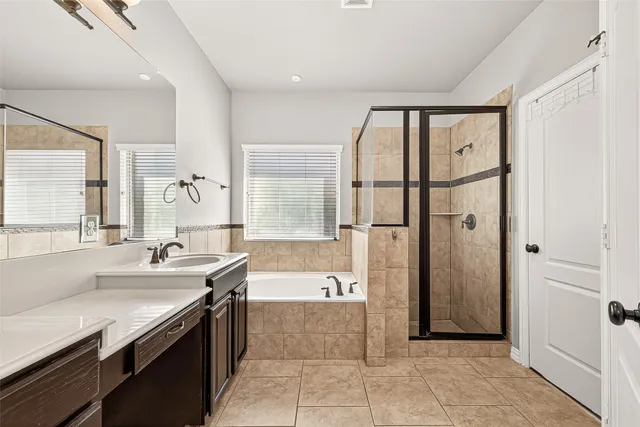 a large bathroom with a large tub shower and sink