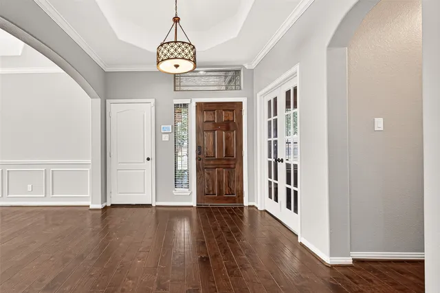 a view of an entryway with wooden floor