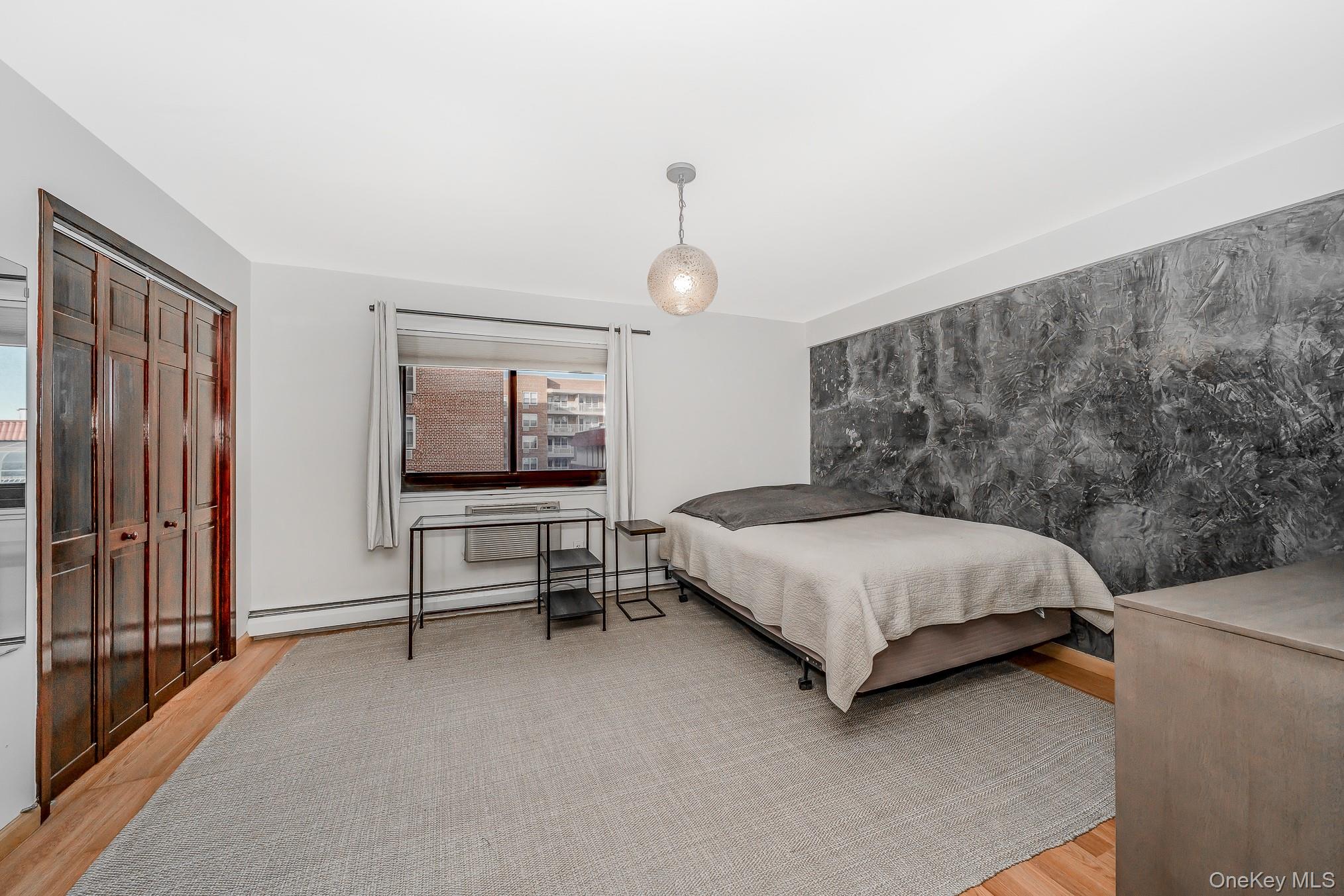 420 Shore Road, Unit 4C Long Beach, NY 11561 - Photo 11 of 41 a bedroom with a bed and large window