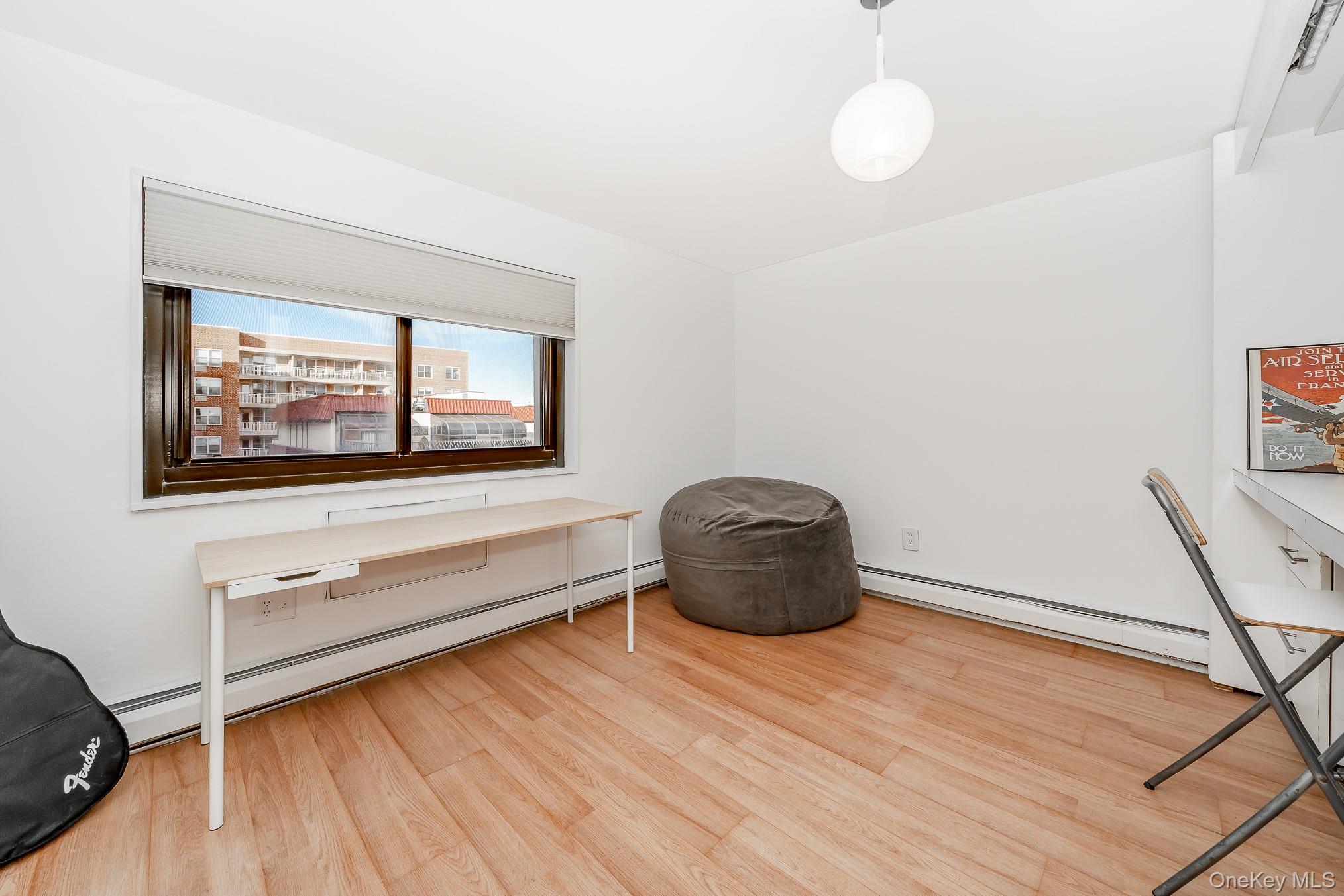 420 Shore Road, Unit 4C Long Beach, NY 11561 - Photo 13 of 41 a room with a wooden floor and windows