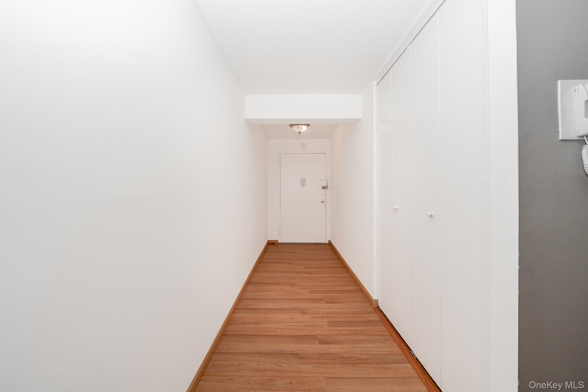 420 Shore Road, Unit 4C Long Beach, NY 11561 - Photo 16 of 41 a view of a hallway with wooden floor