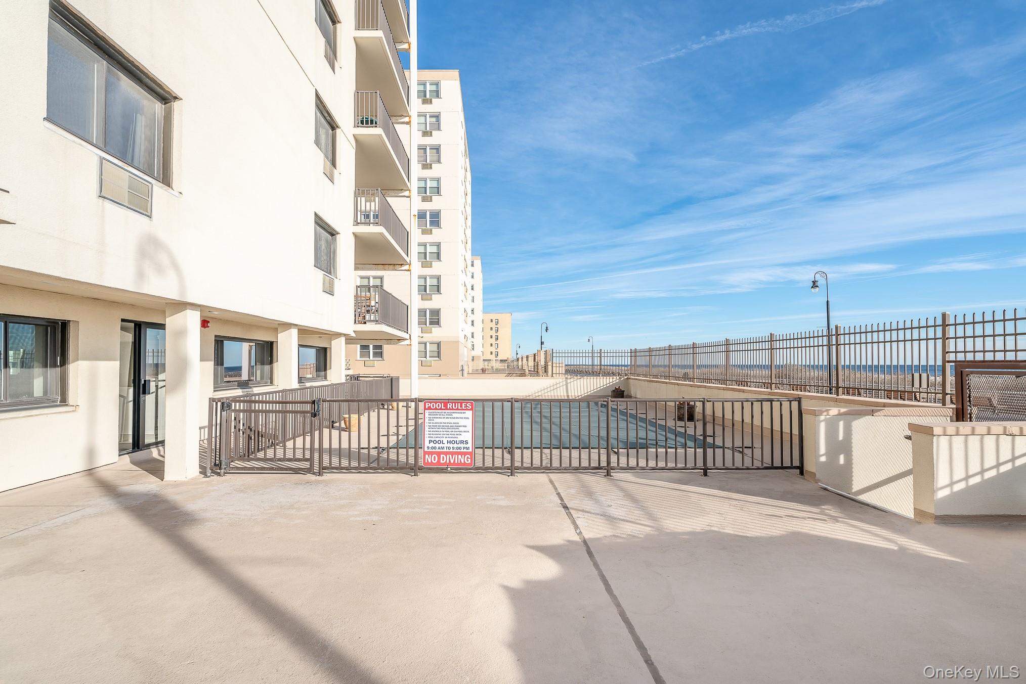 420 Shore Road, Unit 4C Long Beach, NY 11561 - Photo 19 of 41 a view of a building with a bench