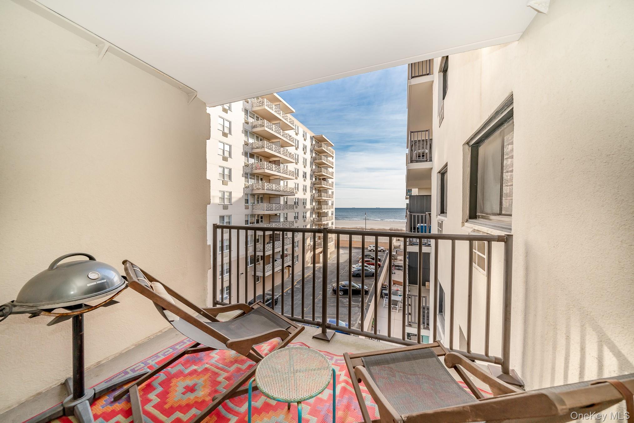 420 Shore Road, Unit 4C Long Beach, NY 11561 - Photo 3 of 41 a view of a balcony with chairs and wooden floor
