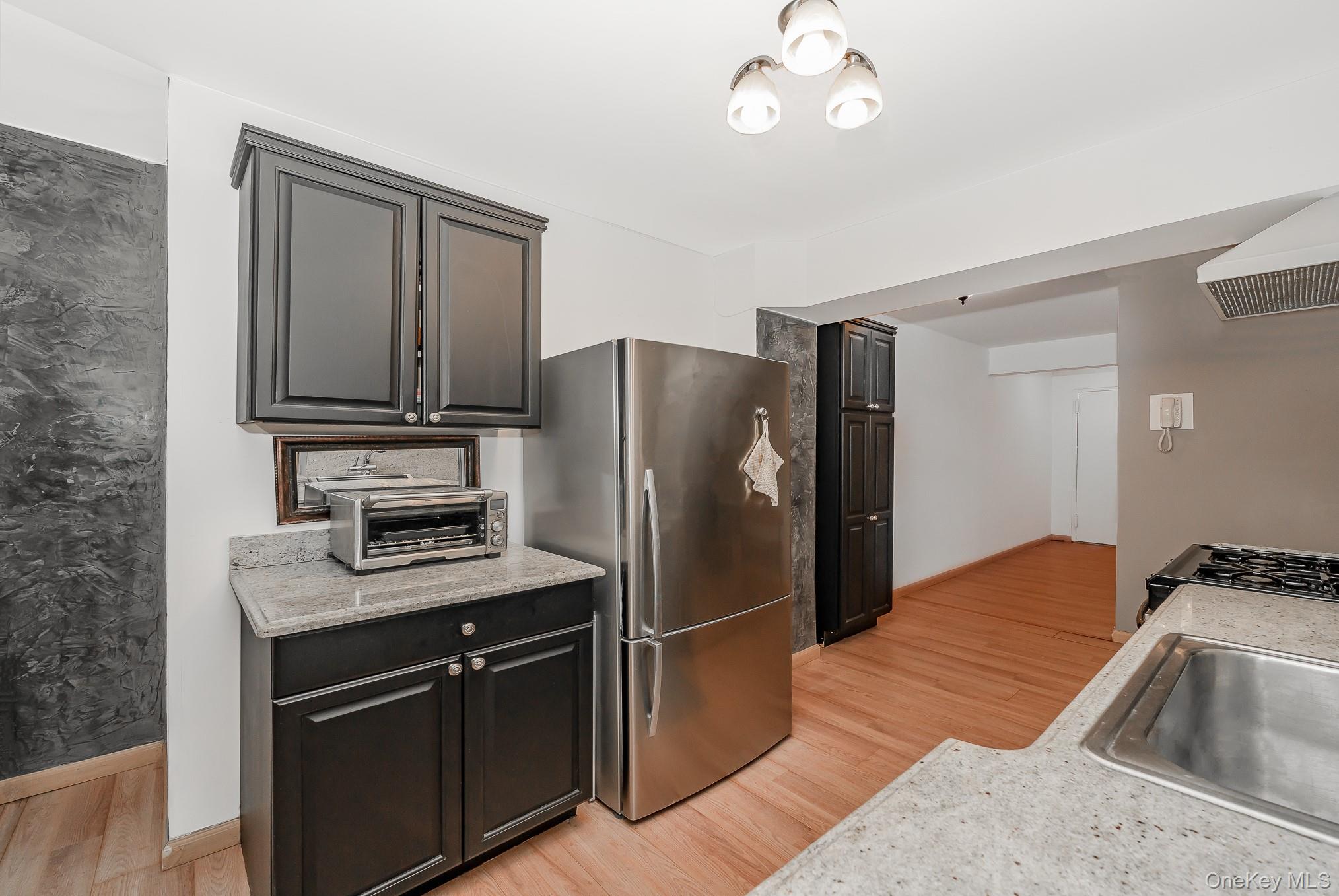 420 Shore Road, Unit 4C Long Beach, NY 11561 - Photo 7 of 41 a kitchen with stainless steel appliances granite countertop a refrigerator a stove a sink and a microwave