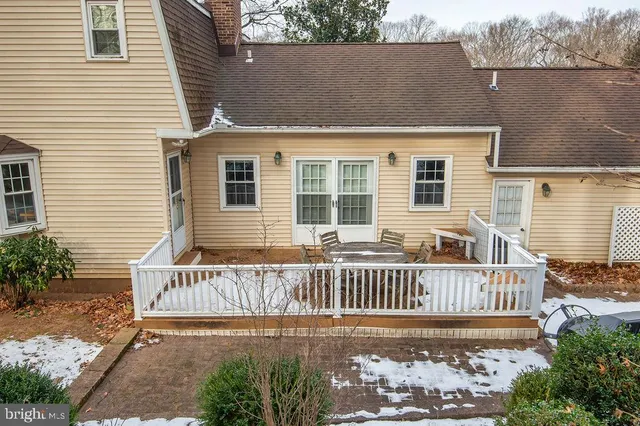 a view of a house with a small yard and wooden fence