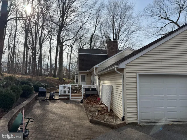 a view of backyard with outdoor seating and trees