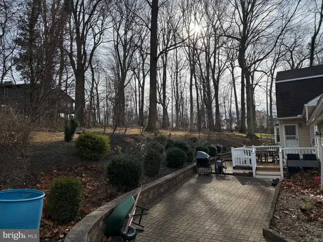 a backyard of a house with barbeque oven and outdoor seating