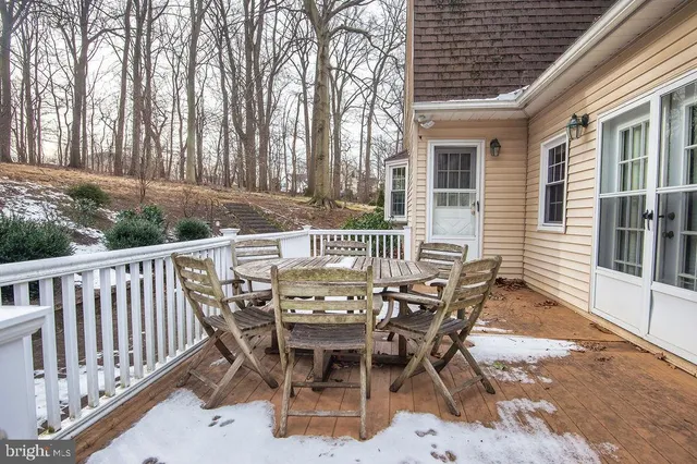 a view of a chairs and table in the roof deck