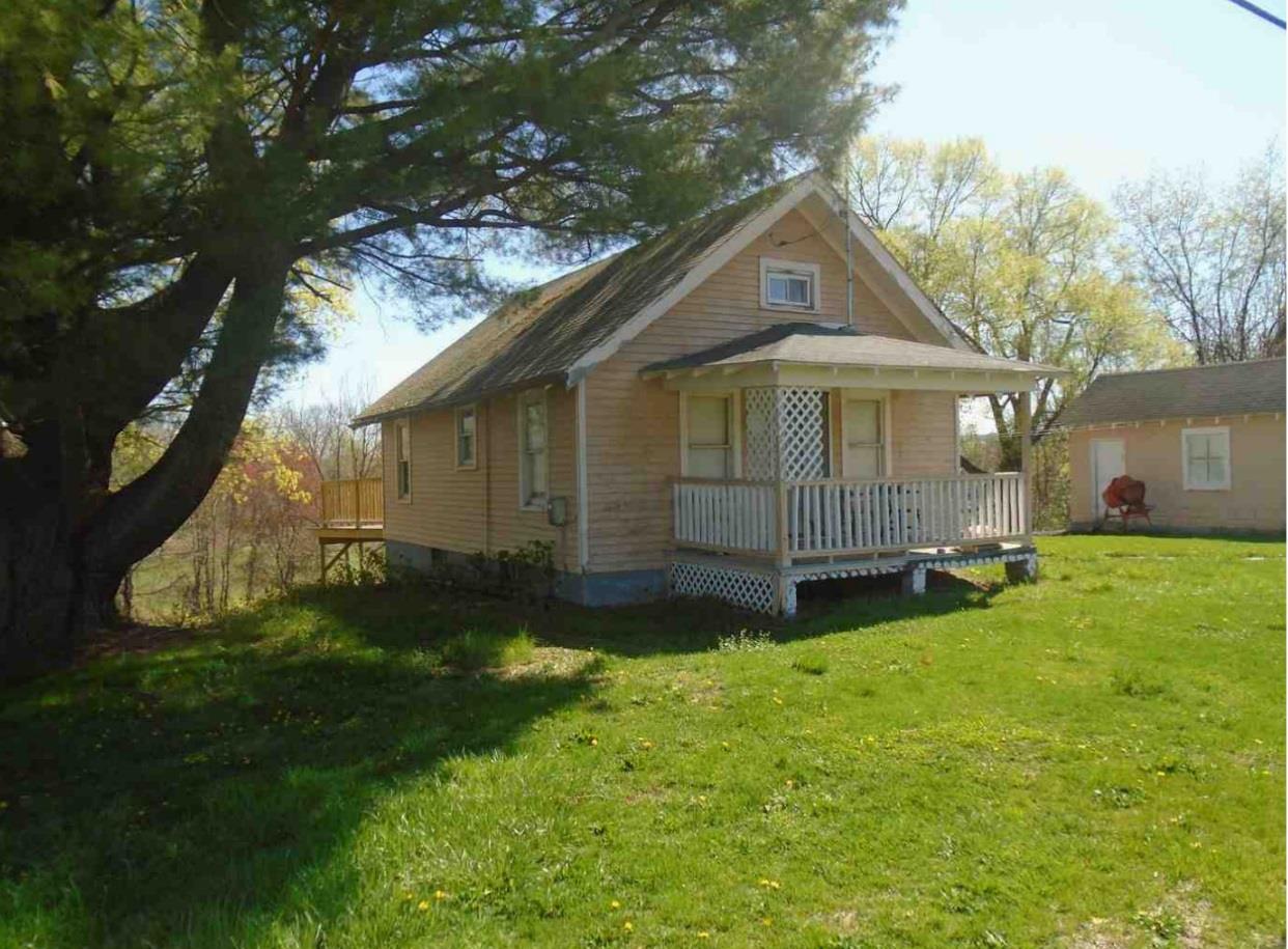 View of front of property featuring a front lawn and the house