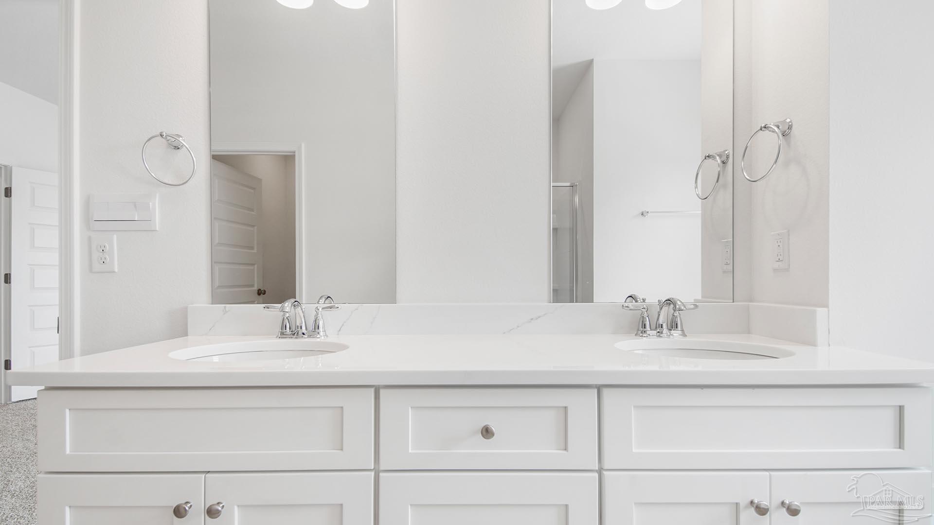 3233 Harrier Road Pace, FL 32571 - Photo 17 of 50 a bathroom with double vanity sink and a mirror