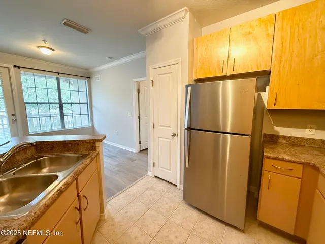 a bathroom with a refrigerator and a sink