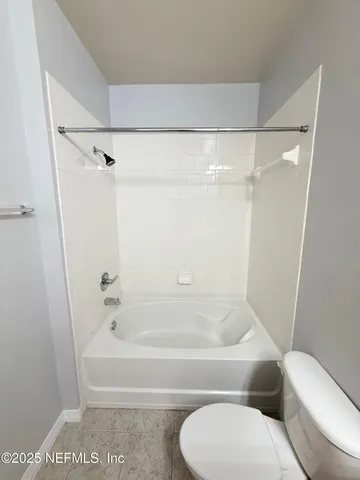 a bathroom with a toilet and a bathtub