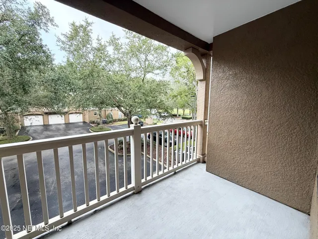a view of a balcony with wooden floor