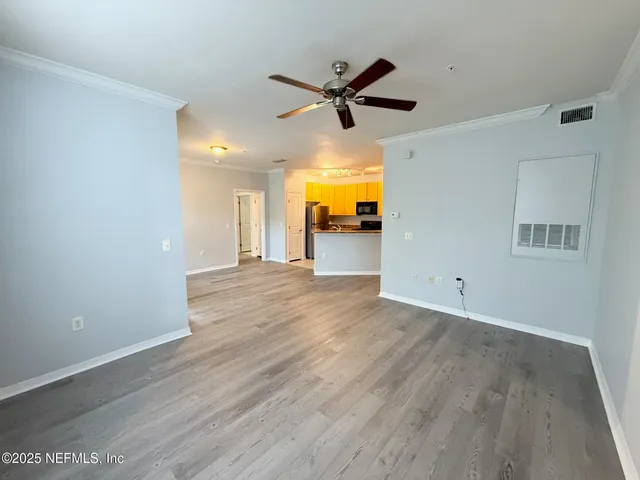 a view of a livingroom with a hardwood floor and a ceiling fan