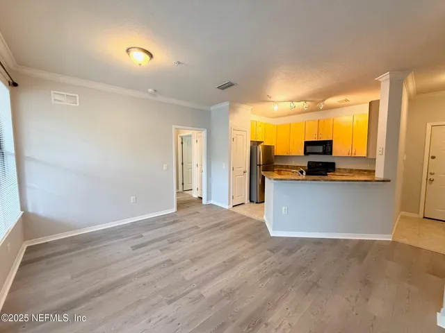 a view of a kitchen with a refrigerator a sink and a dishwasher