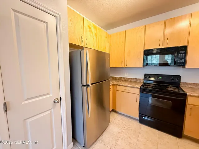 a kitchen with a refrigerator stove and microwave