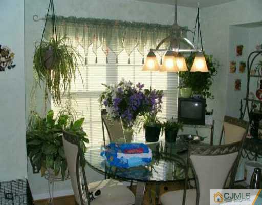 151 Salem Road North Brunswick, NJ 08902 - Photo 2 of 8 a dining room with furniture and a chandelier
