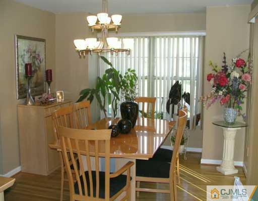 151 Salem Road North Brunswick, NJ 08902 - Photo 3 of 8 a view of a dining room with furniture and chandelier