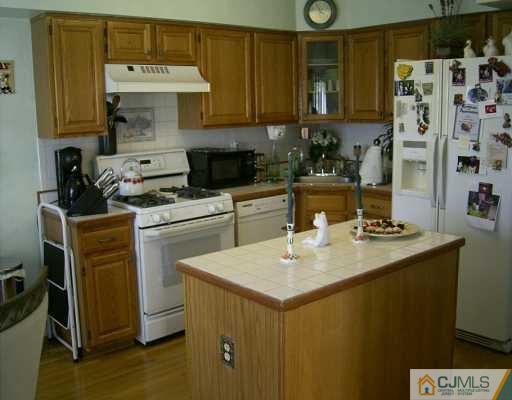 151 Salem Road North Brunswick, NJ 08902 - Photo 4 of 8 a kitchen with a sink and cabinets