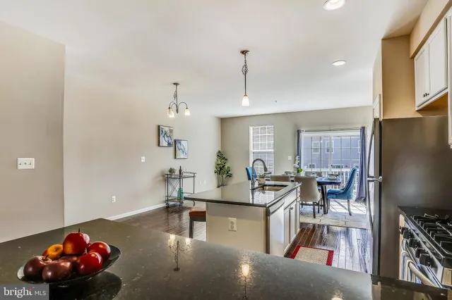 a living room with furniture a chandelier and a flat screen tv