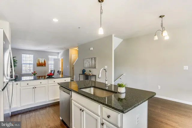 a kitchen with sink and cabinets