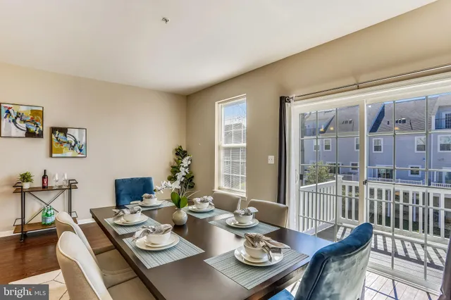 a view of a dining room with furniture large windows and wooden floor