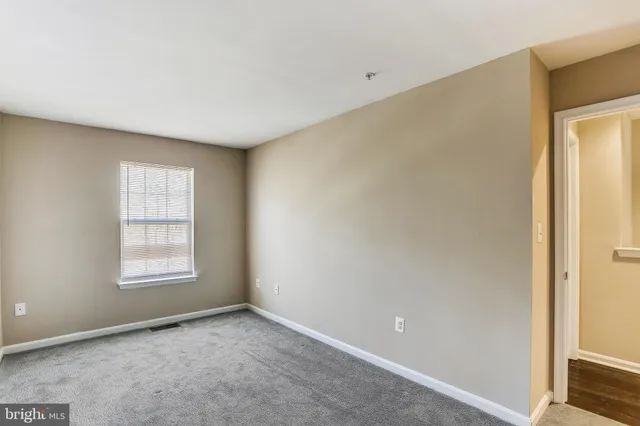 a bedroom with a bed a couch and dresser