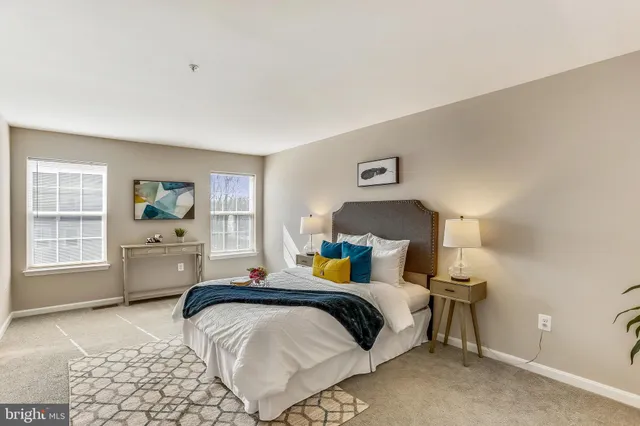 a bedroom with a bed and a lamp