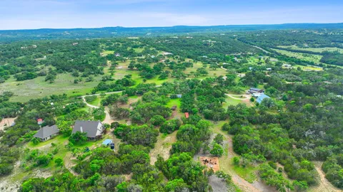 a view of a green field with lots of bushes