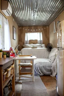 a bedroom with furniture and a window