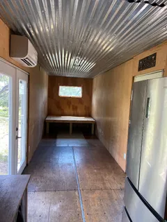 a view of an empty room with a kitchen