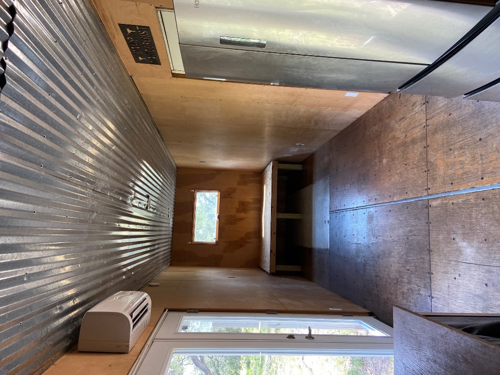 385 Country Lane Dripping Springs, TX 78620 - Photo 7 of 27 a view of an empty room with a kitchen
