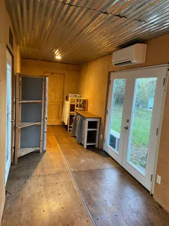 a view of a livingroom with furniture and staircase