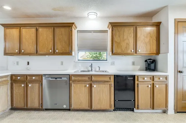 a kitchen with stainless steel appliances granite countertop a sink and a stove