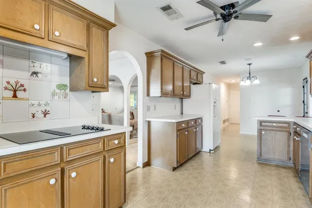 a kitchen with a stove a sink and a refrigerator