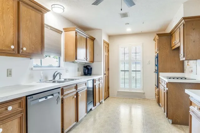 a kitchen with a sink stove and refrigerator