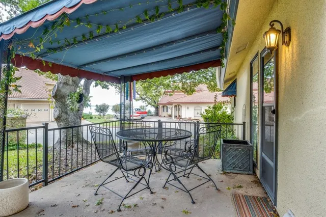 a view of a balcony with chairs and wooden floor