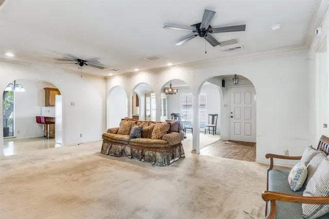 a living room with furniture and a chandelier