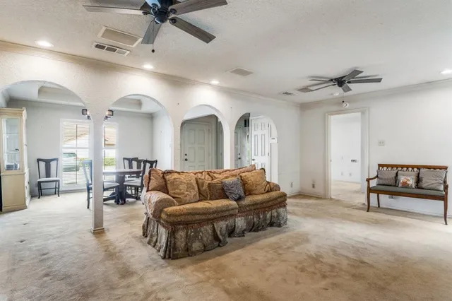 a living room with furniture and a chandelier