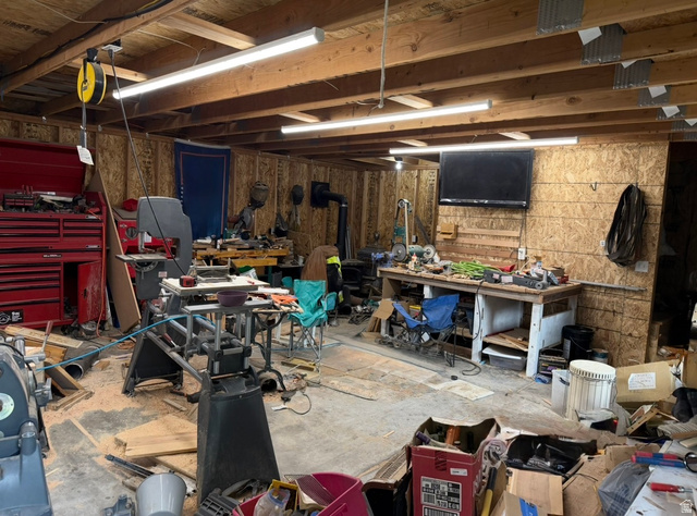 1225 South Main Street Mapleton, UT 84664 - Photo 3 of 9 Workshop featuring overhead fluorescent lighting, workbench and a visible wood-burning stove