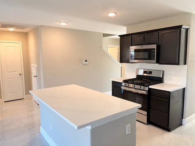 a kitchen with a stove and a microwave