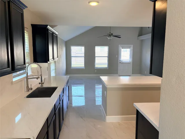 a kitchen with a sink and a refrigerator