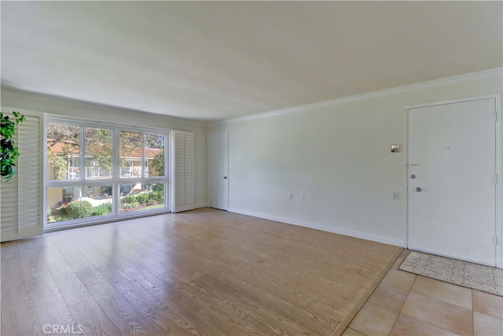912 Ronda Sevilla, Unit O Laguna Woods, CA 92637 - Photo 12 of 55 wooden floor in an empty room with a window