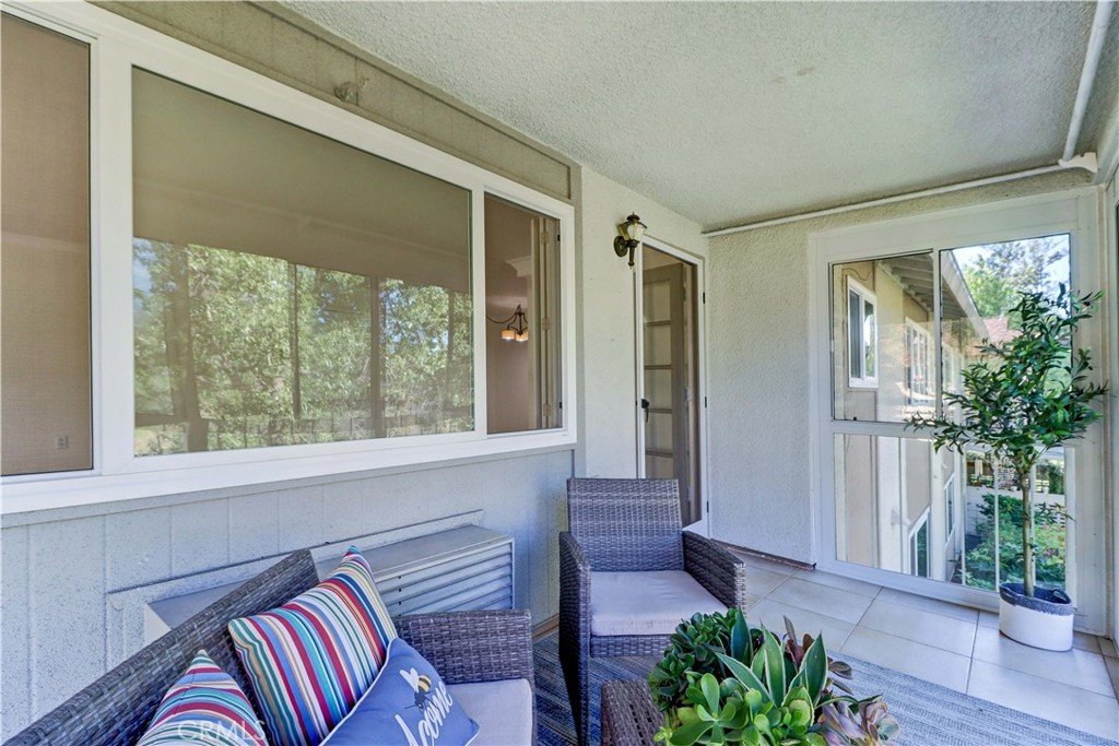 912 Ronda Sevilla, Unit O Laguna Woods, CA 92637 - Photo 30 of 55 a view of a livingroom with furniture and floor to ceiling window