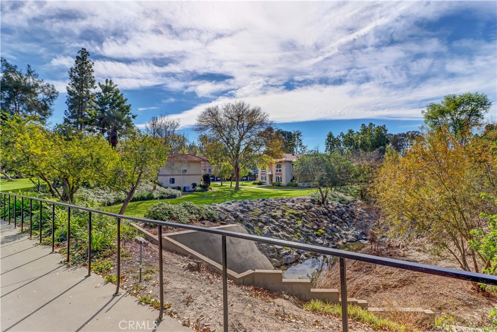912 Ronda Sevilla, Unit O Laguna Woods, CA 92637 - Photo 34 of 55 a view of a garden with a building in the background