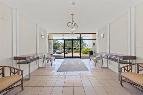 a living room with furniture a pool table and a large window