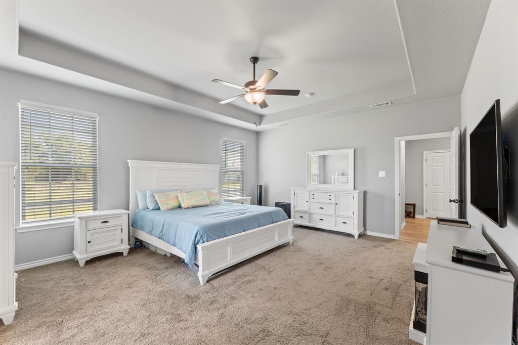 27084 Fm 47 Wills Point Wills Point, TX 75169 - Photo 24 of 36 a spacious bedroom with a bed and a flat tv screen on the dresser
