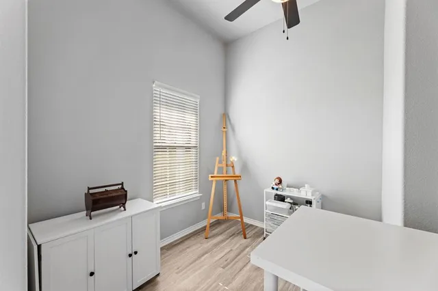 a living room with furniture kitchen view and a wooden floor