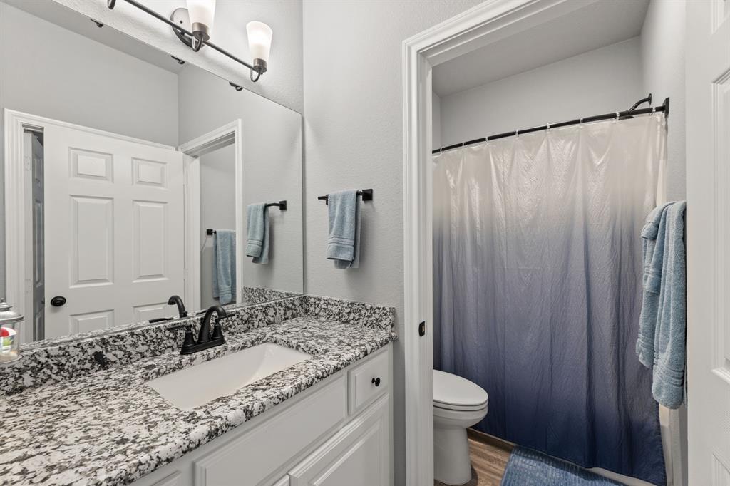 27084 Fm 47 Wills Point Wills Point, TX 75169 - Photo 29 of 36 a bathroom with a granite countertop sink toilet and shower